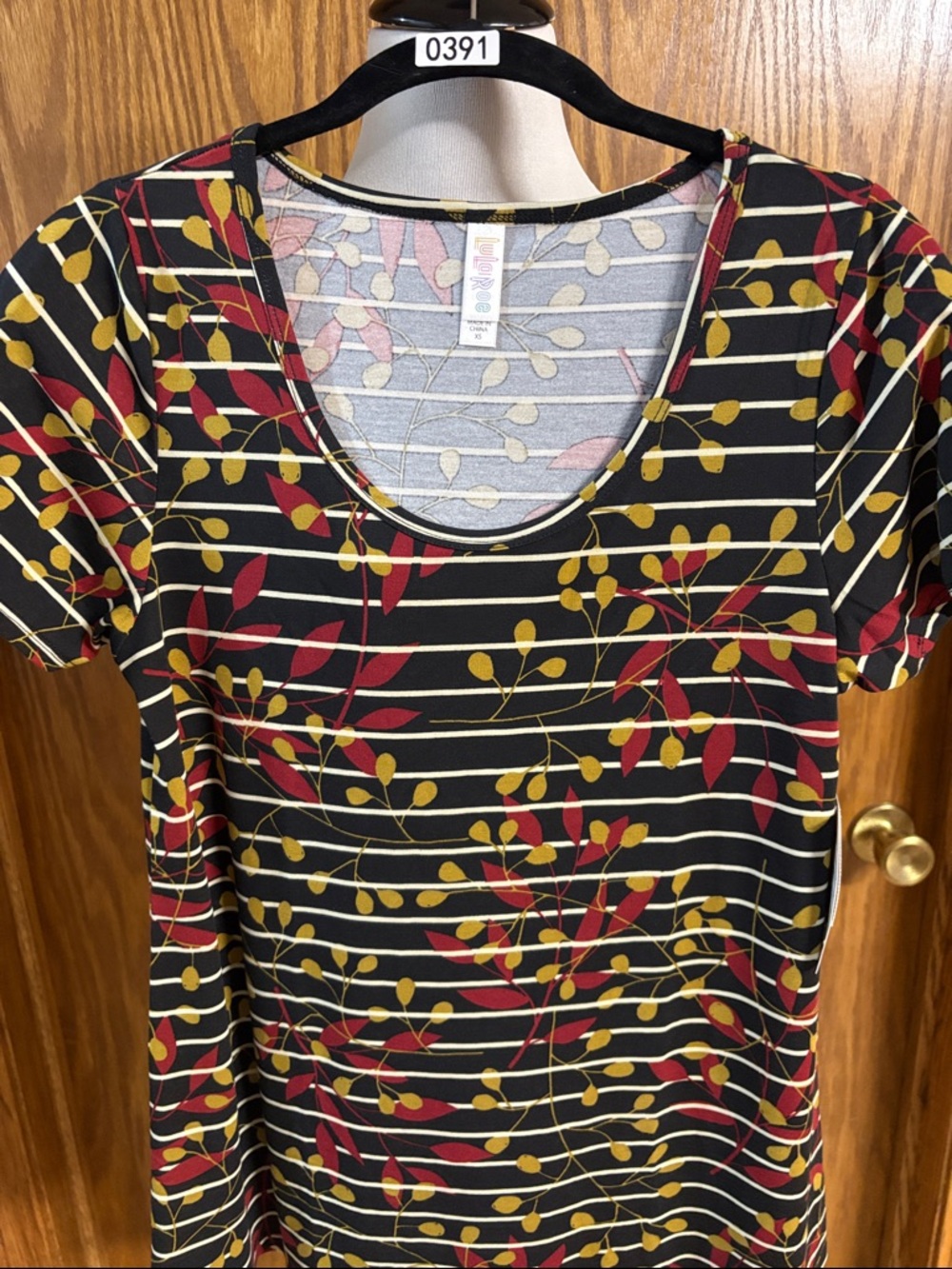 LuLaRoe Black Scoop Neck Tee with Red & Mustard Leaf Print